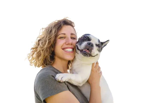 A woman is holding a dog on the roof.