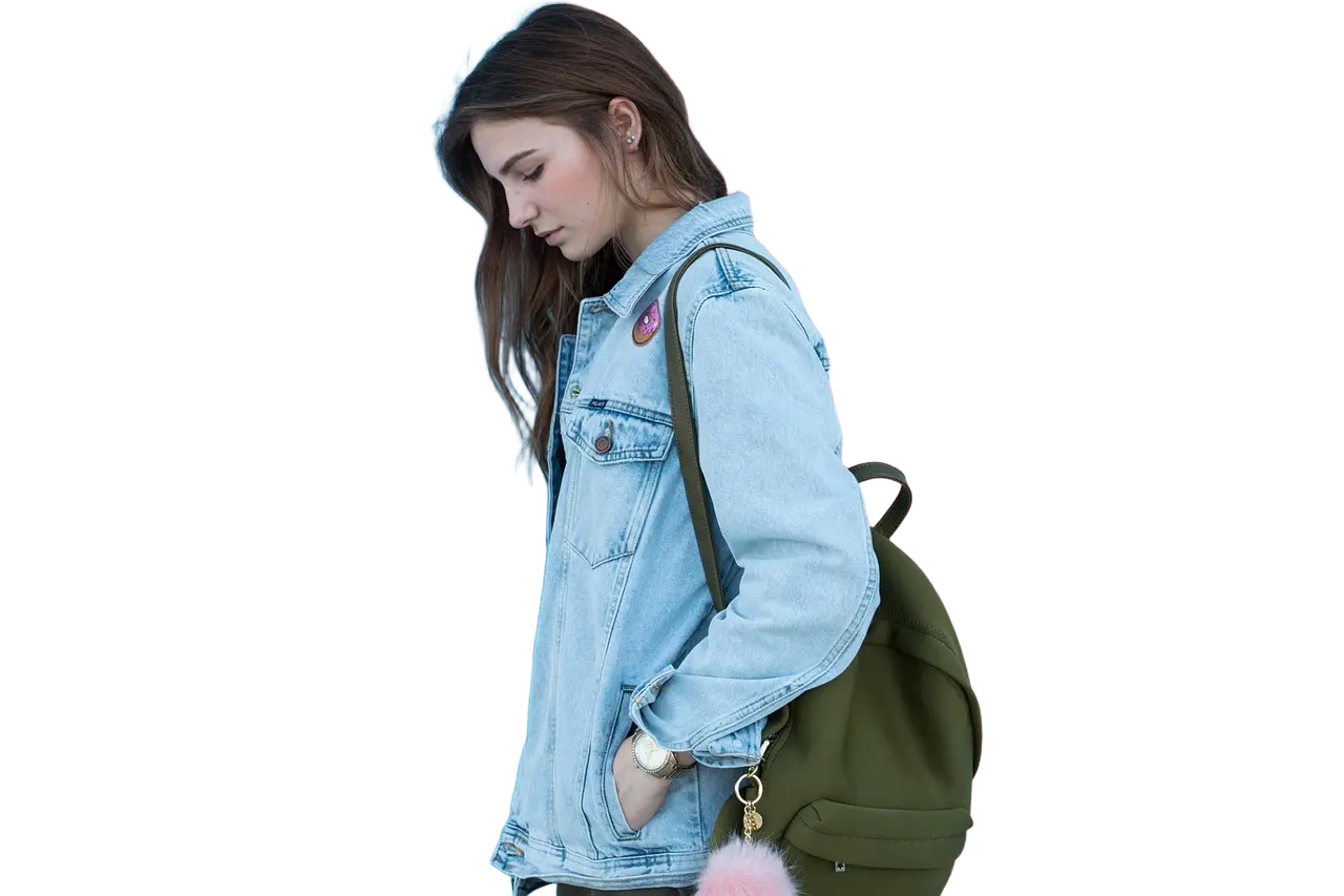 The girl stands before the blue-pink wall.